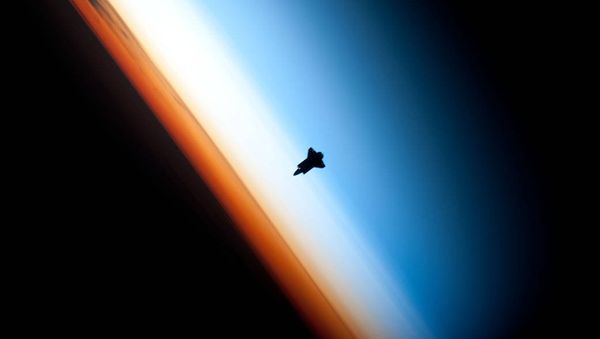 In a very unique setting over Earth's colorful horizon, the silhouette of the space shuttle Endeavour is featured in this photo by an Expedition 22 crew member on board the International Space Station, as the shuttle approached for its docking on Feb. 9 during the STS-130 mission. In a very unique setting over Earth's colorful horizon, the silhouette of the space shuttle Endeavour is featured in this photo by an Expedition 22 crew member on board the International Space Station, as the shuttle approached for its docking on Feb. 9 during the STS-130 mission. - Sputnik International