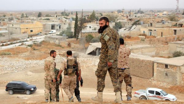 Syrian government forces walk in the village of Jabboul on the eastern outskirts of the northern Syrian city of Aleppo after taking control of the village from Islamic State (IS) group islamists - Sputnik International