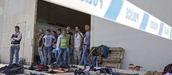 Syrian migrants are temporarily housed at a warehouse after coming ashore at RAF base Akrotiri, Cyprus, Wednesday, Oct. 21, 2015. - Sputnik International
