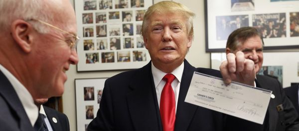 Secretary of State Bill Gardner watches at left as Republican presidential candidate Donald Trump shows off his filling fee check after filing papers to be on the nation's earliest presidential primary ballot. Secretary of State Bill Gardner watches at left as Republican presidential candidate Donald Trump shows off his filling fee check after filing papers to be on the nation's earliest presidential primary ballot. - Sputnik International