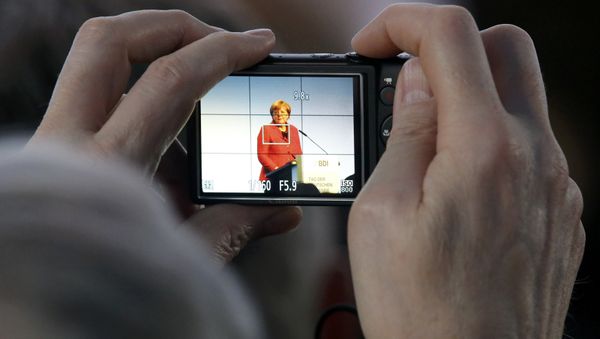 A participant takes a picture as German Chancellor Angela Merkel delivers her speech at the Federation of German Industry (BDI) conference in Berlin, Germany, November 3, 2015. A participant takes a picture as German Chancellor Angela Merkel delivers her speech at the Federation of German Industry (BDI) conference in Berlin, Germany, November 3, 2015. - Sputnik International
