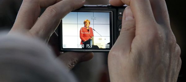 A participant takes a picture as German Chancellor Angela Merkel delivers her speech at the Federation of German Industry (BDI) conference in Berlin, Germany, November 3, 2015. A participant takes a picture as German Chancellor Angela Merkel delivers her speech at the Federation of German Industry (BDI) conference in Berlin, Germany, November 3, 2015. - Sputnik International
