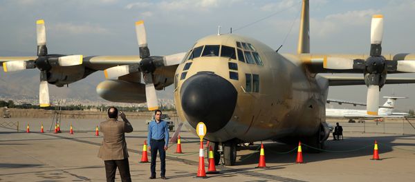 Iranians take pictures in front of a C-130 plane in an exhibition of achievements and equipment of Iran's air force in Tehran, Iran, Wednesday, Sept. 23, 2015 - Sputnik International