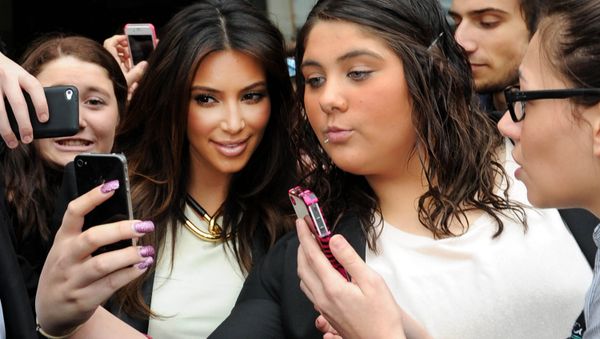 In this Friday, Sept. 21, 2012 file photo Kim Kardashian, left, is surrounded by her fans who are attempting to have their photographs taken with her as she leaves a radio station in Melbourne, Australia. In this Friday, Sept. 21, 2012 file photo Kim Kardashian, left, is surrounded by her fans who are attempting to have their photographs taken with her as she leaves a radio station in Melbourne, Australia. - Sputnik International