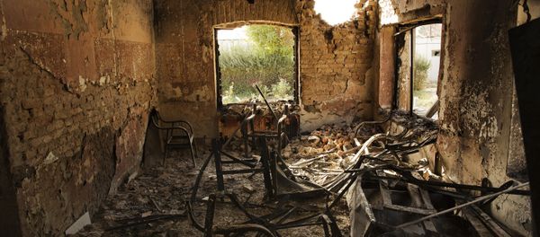 An interior view of the MSF Trauma Centre, 14 October 2015, shows a missile hole in the wall and the burnt-out remians of the the building aftera sustained attack on the facility in Kunduz, northern Afghanistan - Sputnik International