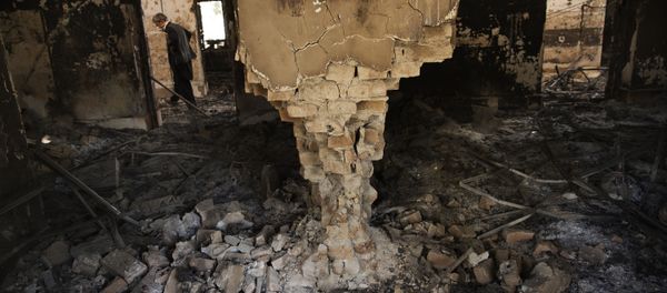A man wearing a surgical mask walks, 14 October 2015, amongst the debris of the damaged and burnt-out MSF Trauma Centre in Kunduz, northern Afghanistan A man wearing a surgical mask walks, 14 October 2015, amongst the debris of the damaged and burnt-out MSF Trauma Centre in Kunduz, northern Afghanistan - Sputnik International