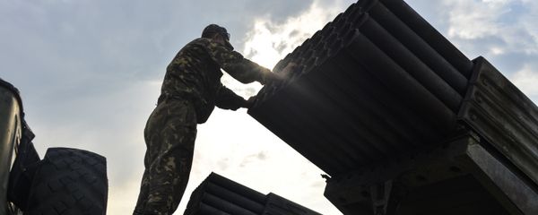 An Ukrainian soldier looks at a Grad multiple rocket launcher system, near the eastern Ukrainian city of Shchastya, Lugansk region, on August 18, 2014 - Sputnik International