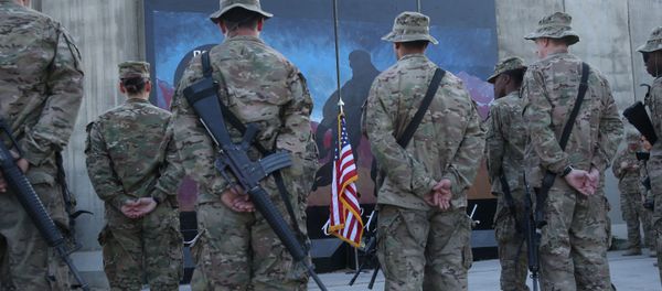 U.S. service members stand in front of a U.S. flag during a ceremony on the thirteenth anniversary of the 9/11 terrorist attacks in front of the World Trade Center Memorial at Bagram Airfield, Afghanistan, Thursday, Sept. 11, 2014 - Sputnik International