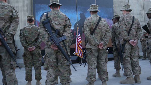 U.S. service members stand in front of a U.S. flag during a ceremony on the thirteenth anniversary of the 9/11 terrorist attacks in front of the World Trade Center Memorial at Bagram Airfield, Afghanistan, Thursday, Sept. 11, 2014 - Sputnik International