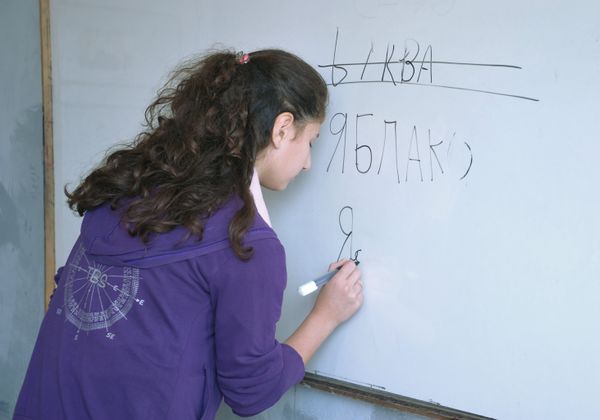 Girl at a whiteboard doing her best to master the challenging Russian Cyrillic script. - Sputnik International