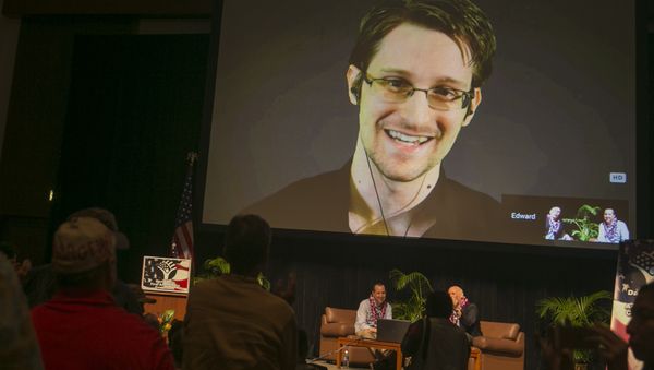National Security Agency leaker Edward Snowden appears on a live video feed broadcast from Moscow at an event sponsored by the ACLU Hawaii in Honolulu on Saturday, Feb. 14, 2015 - Sputnik International