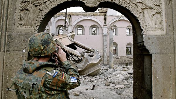 A German KFOR soldier takes photographs of the destroyed St. George Orthodox church in Prizren 22 March 2004 A German KFOR soldier takes photographs of the destroyed St. George Orthodox church in Prizren 22 March 2004 - Sputnik International