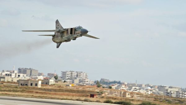 The Soviet-made MiG-23 fighter of the Syrian Air Force flies over the Hama airbase - Sputnik International