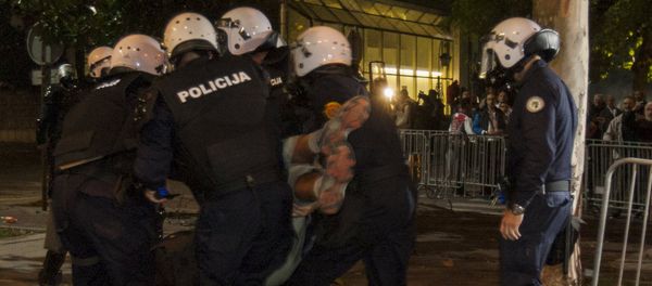 Riot police evacuate an injured demonstrator during protests in the capital Podgorica, Montenegro, October 18, 2015 Riot police evacuate an injured demonstrator during protests in the capital Podgorica, Montenegro, October 18, 2015 - Sputnik International