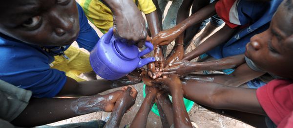 (FILES) A file picture taken on September 3, 2014 shows people washing their hands with soap and bleach to prevent the spread of the Ebola virus - Sputnik International