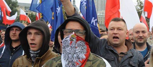 Protesters shout anti migrant slogans as several thousand right wing nationalists march through downtown, demonstrating against EU proposed quotas for Poland to spread the human tide of refugees around Europe, in Warsaw, Poland, Saturday, Sept. 12, 2015 Protesters shout anti migrant slogans as several thousand right wing nationalists march through downtown, demonstrating against EU proposed quotas for Poland to spread the human tide of refugees around Europe, in Warsaw, Poland, Saturday, Sept. 12, 2015 - Sputnik International
