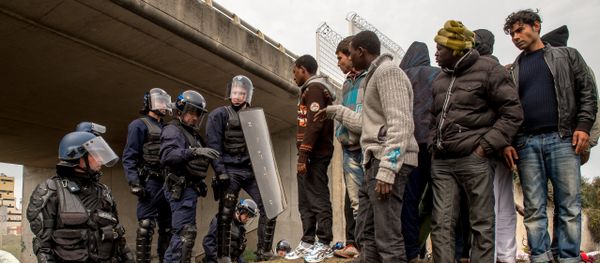 French police officers proceed with operations during the eviction of migrants from a camp site in Calais, northern France, on September 21, 2015 - Sputnik International