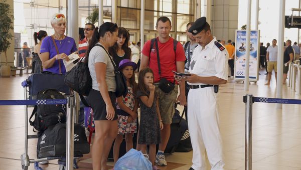British tourists have their documents checked by Egyptian police as they prepare to be evacuated from Sharm el-Sheikh airport, south Sinai, Egypt, Friday, Nov. 6, 2015 British tourists have their documents checked by Egyptian police as they prepare to be evacuated from Sharm el-Sheikh airport, south Sinai, Egypt, Friday, Nov. 6, 2015 - Sputnik International