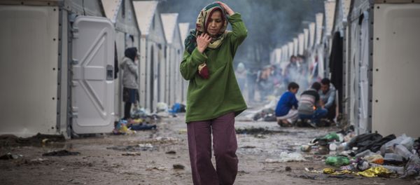 A troubled woman in a migrant camp A troubled woman in a migrant camp - Sputnik International