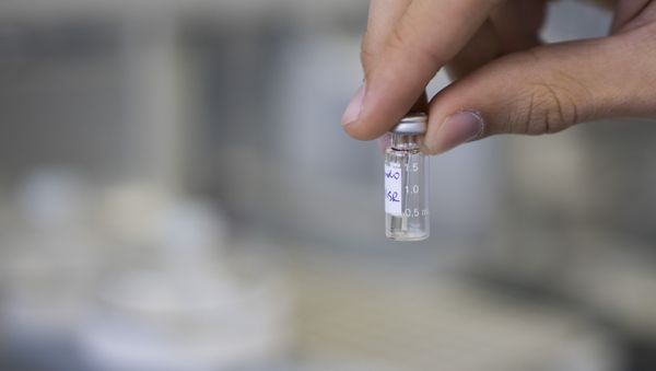 A lab technician shows a sample to be tested for doping A lab technician shows a sample to be tested for doping - Sputnik International