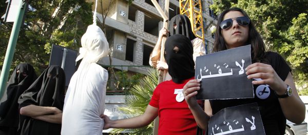 Activists from a civil organization reenact an execution scene in front of the Saudi Arabia Embassy in Beirut, Lebanon, Thursday, April 1, 2010, as they protest a possible beheading of a Lebanese man accused of witchcraft in Saudi Arabia. The lawyer of Lebanese TV psychic Ali Sibat who was convicted in Saudi Arabia for witchcraft said Thursday her client could be beheaded this week and urged Lebanese and Saudi leaders to help spare his life. The Arabic writing on banners read:don't kill. Activists from a civil organization reenact an execution scene in front of the Saudi Arabia Embassy in Beirut, Lebanon, Thursday, April 1, 2010, as they protest a possible beheading of a Lebanese man accused of witchcraft in Saudi Arabia. The lawyer of Lebanese TV psychic Ali Sibat who was convicted in Saudi Arabia for witchcraft said Thursday her client could be beheaded this week and urged Lebanese and Saudi leaders to help spare his life. The Arabic writing on banners read:don't kill. - Sputnik International