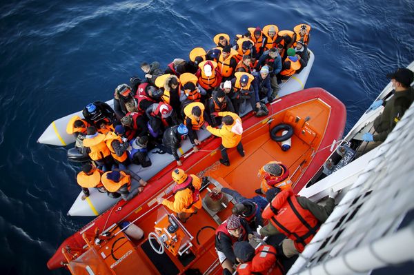 Refugees and migrants board the Turkish Coast Guard Search and Rescue ship Umut-703, off the shores of Canakkale, Turkey, after a failed attempt at crossing to the Greek island of Lesbos, November 9, 2015 - Sputnik International