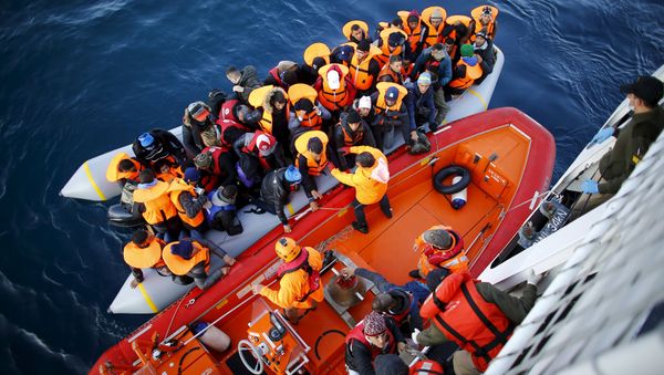 Refugees and migrants board the Turkish Coast Guard Search and Rescue ship Umut-703, off the shores of Canakkale, Turkey, after a failed attempt at crossing to the Greek island of Lesbos, November 9, 2015. Refugees and migrants board the Turkish Coast Guard Search and Rescue ship Umut-703, off the shores of Canakkale, Turkey, after a failed attempt at crossing to the Greek island of Lesbos, November 9, 2015. - Sputnik International