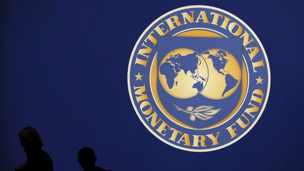 Visitors are silhouetted against the logo of the International Monetary Fund at the main venue for the IMF and World Bank annual meeting in Tokyo in this October 10, 2012 file photo. Visitors are silhouetted against the logo of the International Monetary Fund at the main venue for the IMF and World Bank annual meeting in Tokyo in this October 10, 2012 file photo. - Sputnik International