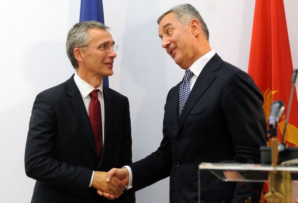 Montenegro's Prime Minister Milo Djukanovic (R) shakes hands with NATO Secretary General Jens Stoltenberg after a joint press conference in Podgorica, October 2015 - Sputnik International