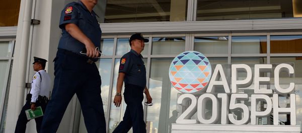 Philippine policemen walk past an Asia Pacific Economic Cooperation (APEC) summit logo in front of the media centre in Manila on November 11, 2015 Philippine policemen walk past an Asia Pacific Economic Cooperation (APEC) summit logo in front of the media centre in Manila on November 11, 2015 - Sputnik International