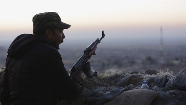 A Kurdish fighter, known as a peshmerga, yawns as he stands guard on the frontline in Sinjar, Iraq, Friday, Nov. 13, 2015. A Kurdish fighter, known as a peshmerga, yawns as he stands guard on the frontline in Sinjar, Iraq, Friday, Nov. 13, 2015. - Sputnik International