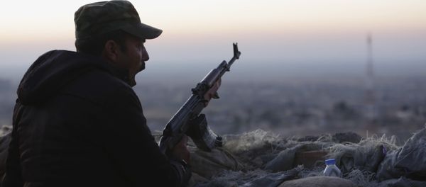A Kurdish fighter, known as a peshmerga, yawns as he stands guard on the frontline in Sinjar, Iraq, Friday, Nov. 13, 2015. A Kurdish fighter, known as a peshmerga, yawns as he stands guard on the frontline in Sinjar, Iraq, Friday, Nov. 13, 2015. - Sputnik International