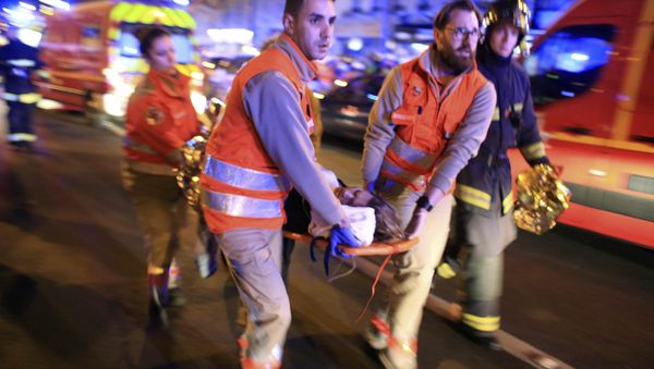 A woman is being evacuated from the Bataclan theater after a shooting in Paris, Friday Nov. 13, 2015 A woman is being evacuated from the Bataclan theater after a shooting in Paris, Friday Nov. 13, 2015 - Sputnik International