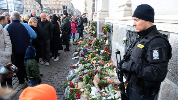 People place flowers in front of the French Embassy in Copenhagen, Denmark, Saturday, Nov. 14, 2015, as people gather with condolences for the victims of Friday's attacks in Paris - Sputnik International