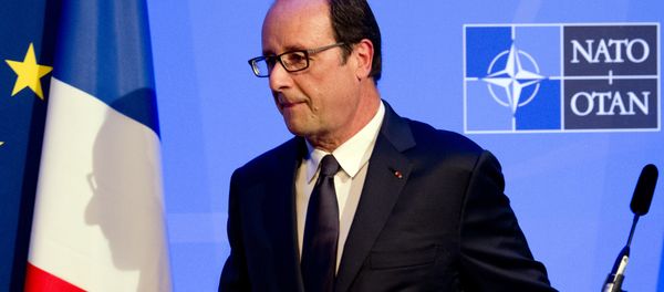 A shadow of France's President Francois Hollande is cast on a flag as he leaves a press conference on the second day of the NATO 2014 Summit at the Celtic Manor Resort in Newport, South Wales, on September 5, 2014 A shadow of France's President Francois Hollande is cast on a flag as he leaves a press conference on the second day of the NATO 2014 Summit at the Celtic Manor Resort in Newport, South Wales, on September 5, 2014 - Sputnik International