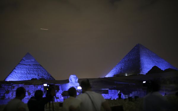 Egyptians watch the historical site of the Giza Pyramids as they are illuminated with blue light, as part of the celebration of the 70th anniversary of the United Nations, in Giza, just outside Cairo, Egypt, Saturday, Oct. 24, 2015 Egyptians watch the historical site of the Giza Pyramids as they are illuminated with blue light, as part of the celebration of the 70th anniversary of the United Nations, in Giza, just outside Cairo, Egypt, Saturday, Oct. 24, 2015 - Sputnik International