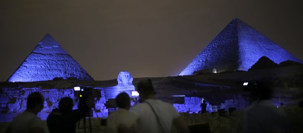 Egyptians watch the historical site of the Giza Pyramids as they are illuminated with blue light, as part of the celebration of the 70th anniversary of the United Nations, in Giza, just outside Cairo, Egypt, Saturday, Oct. 24, 2015 Egyptians watch the historical site of the Giza Pyramids as they are illuminated with blue light, as part of the celebration of the 70th anniversary of the United Nations, in Giza, just outside Cairo, Egypt, Saturday, Oct. 24, 2015 - Sputnik International