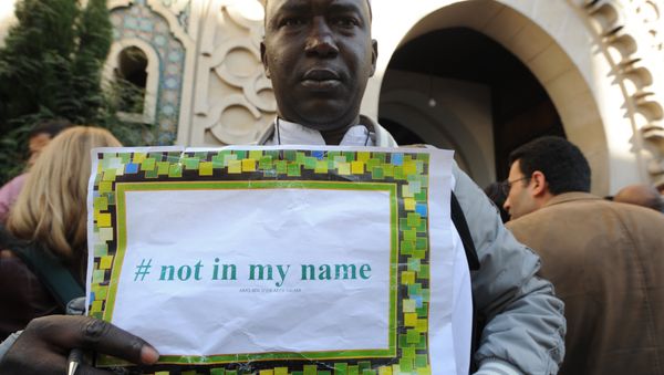 File photo of a man holds a placard reading Not in my name during a demonstration called by muslims groups to denounce the barbarism of Islamic State militants, on September 26, 2014 outside Paris's main mosque File photo of a man holds a placard reading Not in my name during a demonstration called by muslims groups to denounce the barbarism of Islamic State militants, on September 26, 2014 outside Paris's main mosque - Sputnik International