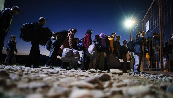 Migrants and refugees enter a registration camp after crossing the Greek-Macedonian border near Gevgelija on November 13, 2015 - Sputnik International