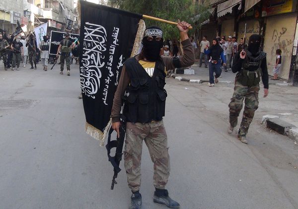 Islamic fighters from the al-Qaida group in the Levant, Al-Nusra Front, wave their movement's flag as they parade at the Yarmuk Palestinian refugee camp, south of Damascus, to denounce Israel’s military offensive on the Gaza Strip, on July 28, 2014 - Sputnik International