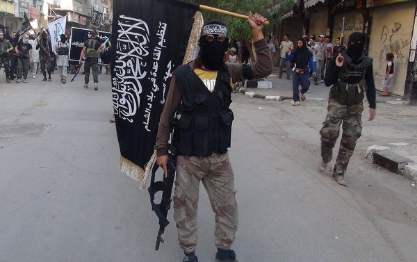 Islamic fighters from the al-Qaida group in the Levant, Al-Nusra Front, wave their movement's flag as they parade at the Yarmuk Palestinian refugee camp, south of Damascus, to denounce Israel’s military offensive on the Gaza Strip, on July 28, 2014 - Sputnik International