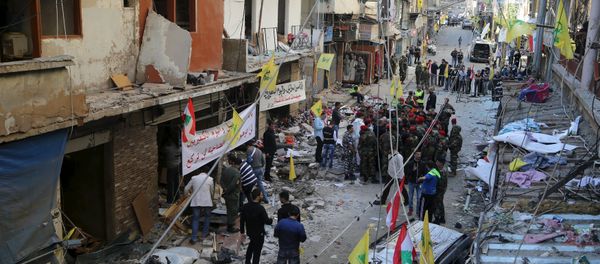 Lebanese army soldiers and security forces gather as Lebanese and Hezbollah flags are erected at the site of the two explosions that occured on Thursday in the southern suburbs of the Lebanese capital Beirut, November 13, 2015 Lebanese army soldiers and security forces gather as Lebanese and Hezbollah flags are erected at the site of the two explosions that occured on Thursday in the southern suburbs of the Lebanese capital Beirut, November 13, 2015 - Sputnik International