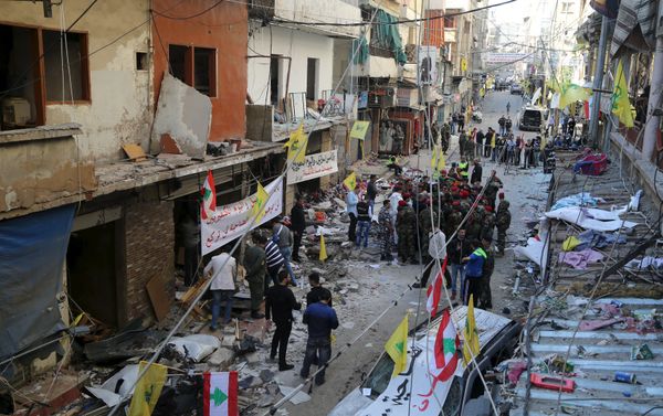 Lebanese army soldiers and security forces gather as Lebanese and Hezbollah flags are erected at the site of the two explosions that occured on Thursday in the southern suburbs of the Lebanese capital Beirut, November 13, 2015 Lebanese army soldiers and security forces gather as Lebanese and Hezbollah flags are erected at the site of the two explosions that occured on Thursday in the southern suburbs of the Lebanese capital Beirut, November 13, 2015 - Sputnik International