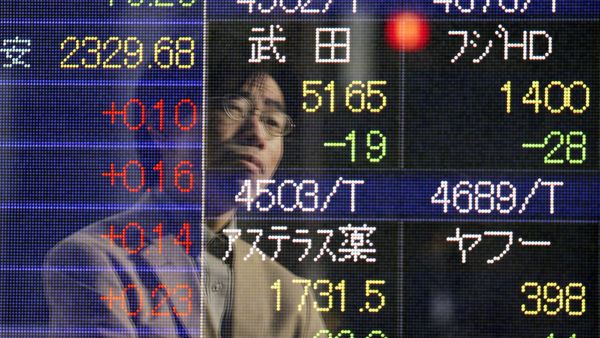 A man is reflected on an electronic board of a securities firm in Tokyo Friday, Jan. 16, 2015. - Sputnik International