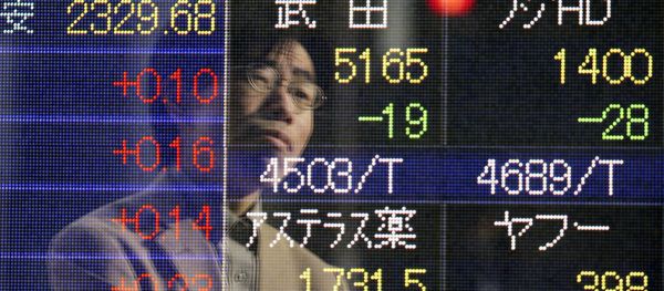 A man is reflected on an electronic board of a securities firm in Tokyo Friday, Jan. 16, 2015. - Sputnik International