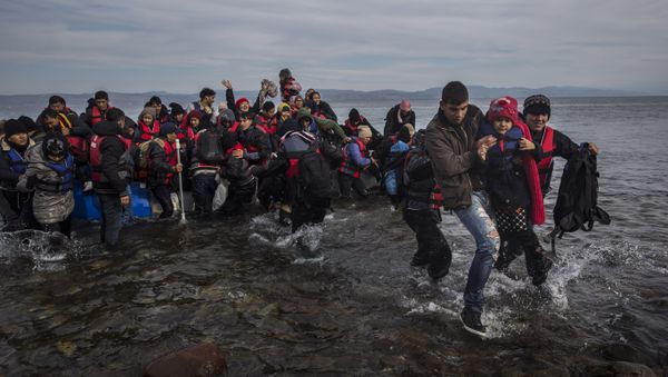 Migrants and refugees disembark safely from a dinghy at a beach on the Greek island of Lesbos after crossing the Aegean sea from the Turkish coast, Monday, Nov. 16, 2015 Migrants and refugees disembark safely from a dinghy at a beach on the Greek island of Lesbos after crossing the Aegean sea from the Turkish coast, Monday, Nov. 16, 2015 - Sputnik International
