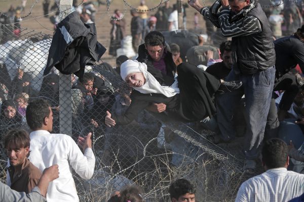 FILE - In this Sunday, June 14, 2015 file photo, Syrian refugees are helped into Turkey after breaking the border fence and crossing from Syria in Akcakale, Sanliurfa province, southeastern Turkey FILE - In this Sunday, June 14, 2015 file photo, Syrian refugees are helped into Turkey after breaking the border fence and crossing from Syria in Akcakale, Sanliurfa province, southeastern Turkey - Sputnik International