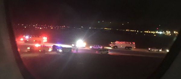 Emergency personnel are shown on the tarmac at Salt Lake City International Airport in this photograph taken by passenger Keith Rosso from a seat inside Air France flight 65, November 17, 2015 - Sputnik International