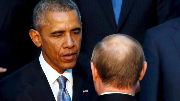 U.S. President Barack Obama shakes hands with Russia's President Vladimir Putin (back to camera) as they gather for a family photo with fellow world leaders at the start of the G20 summit at the Regnum Carya Resort in Antalya, Turkey, November 15, 2015 - Sputnik International