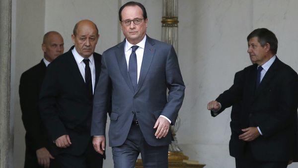 French President Francois Hollande (C) and French Defence minister Jean-Yves Le Drian (L) leave the weekly cabinet meeting at the Elysee Palace in Paris French President Francois Hollande (C) and French Defence minister Jean-Yves Le Drian (L) leave the weekly cabinet meeting at the Elysee Palace in Paris - Sputnik International